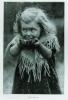 A young girl eating 'war bread'. ca. 1915