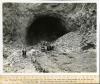The concrete arch coffer dams are being blasted out of the lower portals of diversion tunnels. The concrete arch coffer dams are being blasted out of the lower portals of diversion tunnels, shown here Tunnel #2.05/15/1932