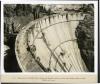 Looking down on Boulder Dam, showing the finished roadway and the Intake Bridge girders in place.  03/25/1935