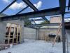 View of trusses supporting roof beam and partial demolition of chimney