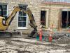 Excavator fills in trench dug for drainage pipes, September 23, 2025