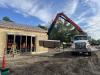 Truck crane unloading drywall into the building, September 24, 2025