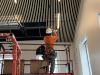 Worker installs ceiling panels in new Lobby expansion, March 4, 2026