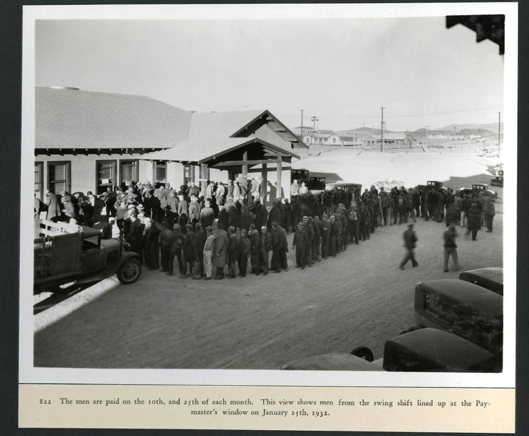 Men from the swing shift lined up at the Paymaster's winder to receive their checks. 01/25/1932