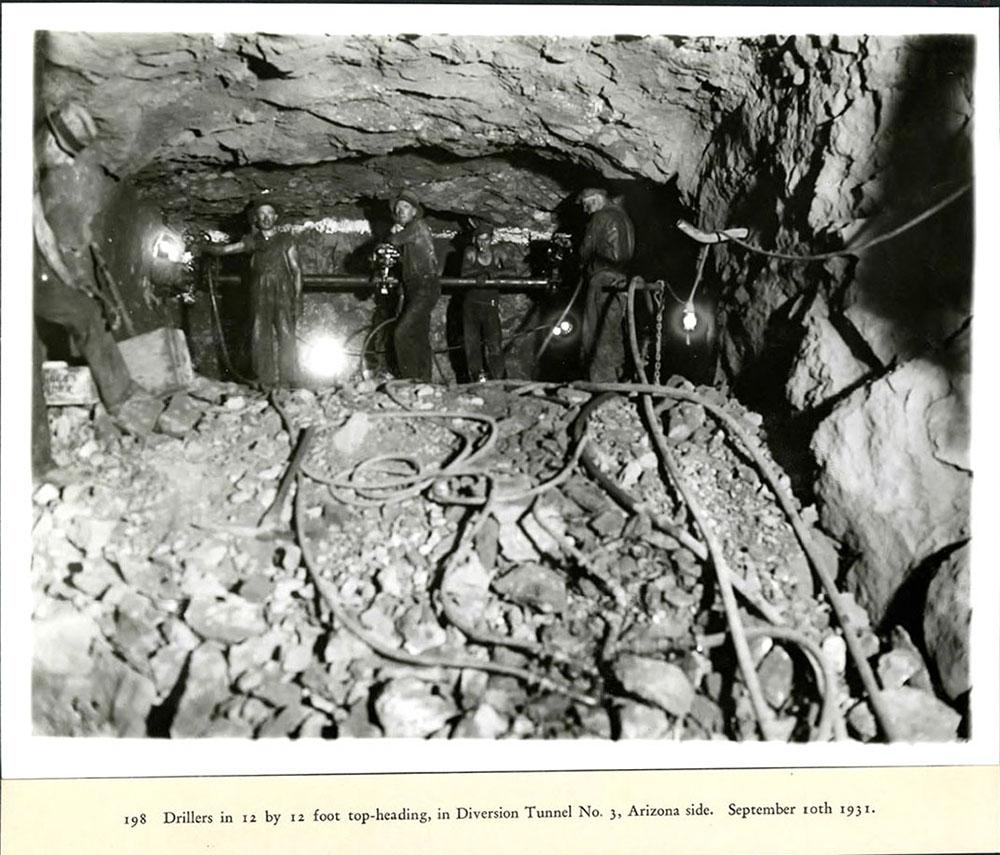 Drillers in a 12 by 12 foot top-heading, in diversion Tunnel #3, Arizona side. 09/10/1931