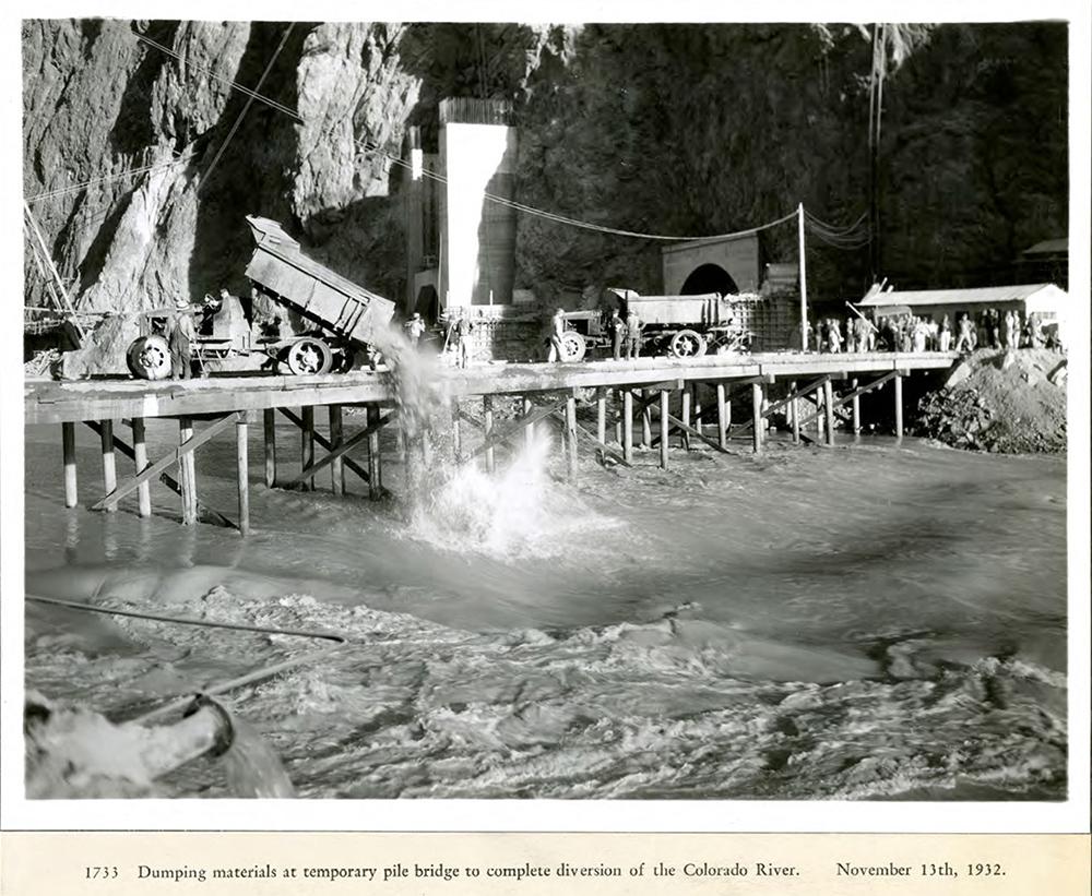 Dumping materials at temporary pile bridge to complete diversion of the Colorado River. 11/13/1932