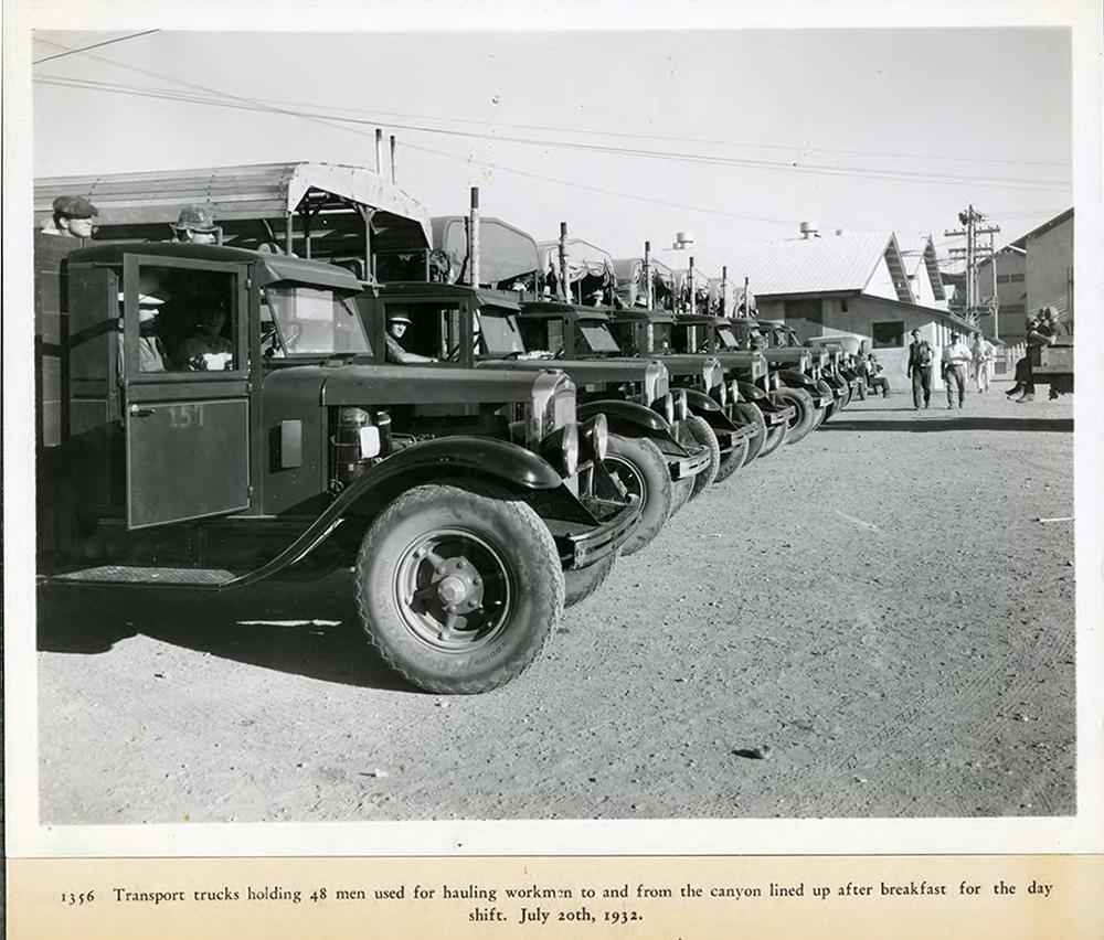 Transport trucks used for hauling workers to and from the canyon line up after breakfast for the day shift. 07/20/1932