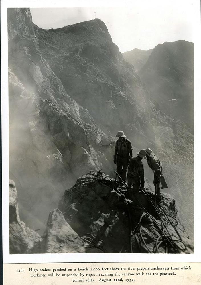 High scalers, 1000 feet above the river secure anchorages for which workman will be suspended by ropes when scaling the canyon walls. 08/22/1932