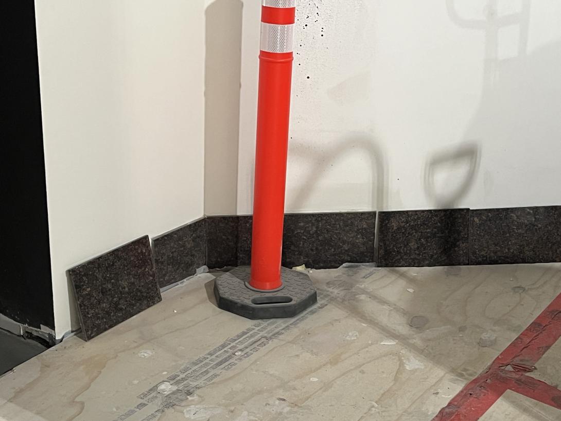 Original marble tiles being placed in new Story Hub, March 4, 2026 