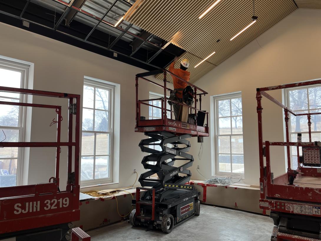 Worker installs ceiling panels in new Lobby expansion, March 4, 2026