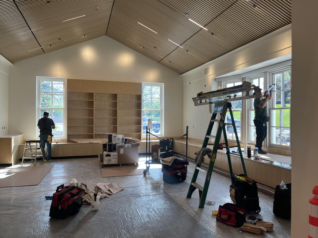 Workers applying sealant to new windows in gift shop, April 29, 2026