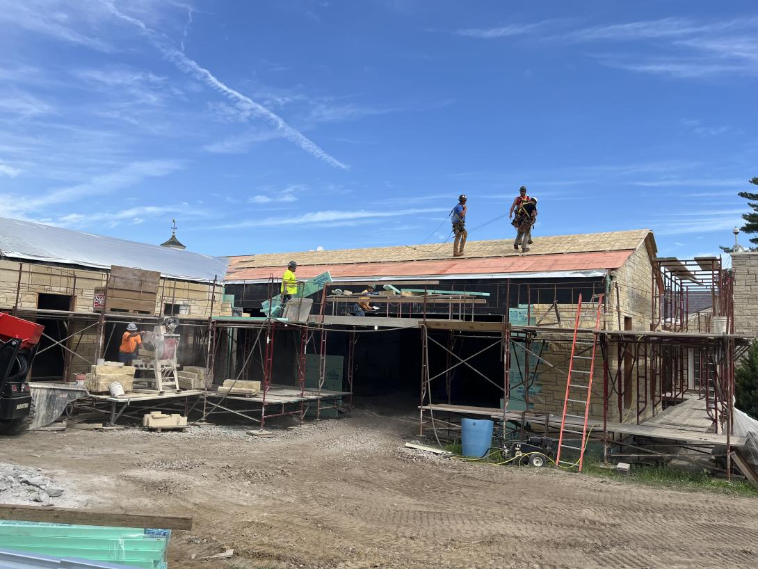 Work crew installing roof insulation, July 2, 2025