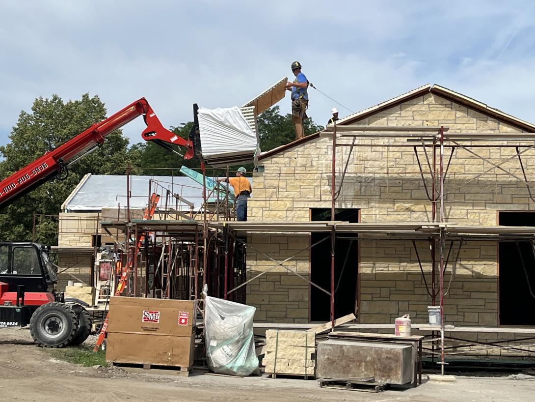 Work crew installing roof insulation, July 2, 2025