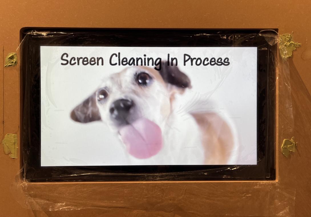 A playful image of a dog licking a screen captioned, "Screen Cleaning in Progress" May 13, 2026