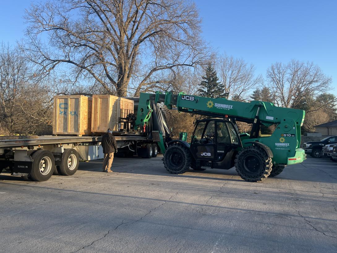 Removing crates of scenic backdrop to be installed in the Museum, March 23, 2026