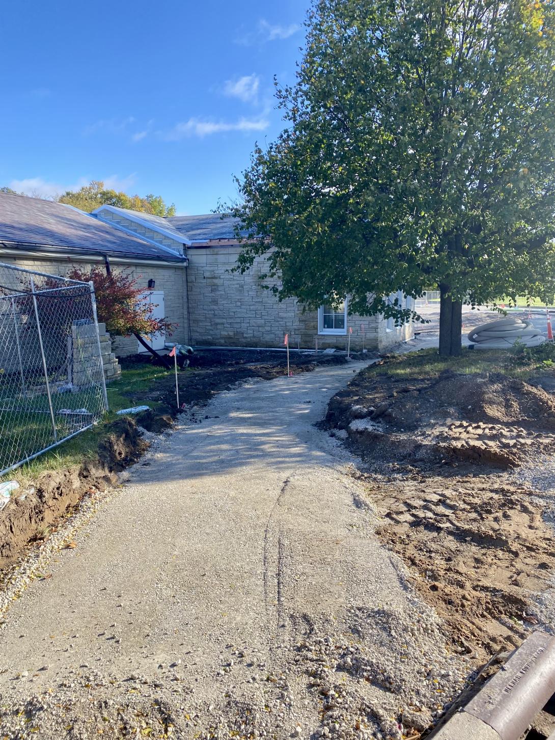 Land graded for sidewalk leading to new entrance, October 22, 2025